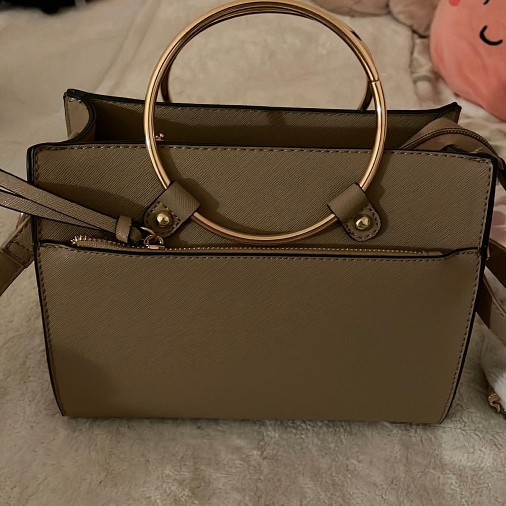 Sand color handle bag with gold hardware.